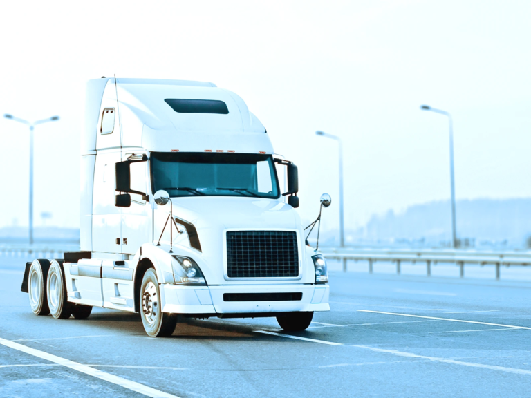 White semi truck on highway without a trailer