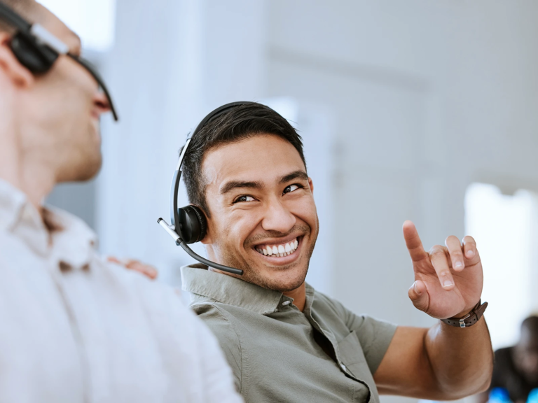 Smiling man in office with headset