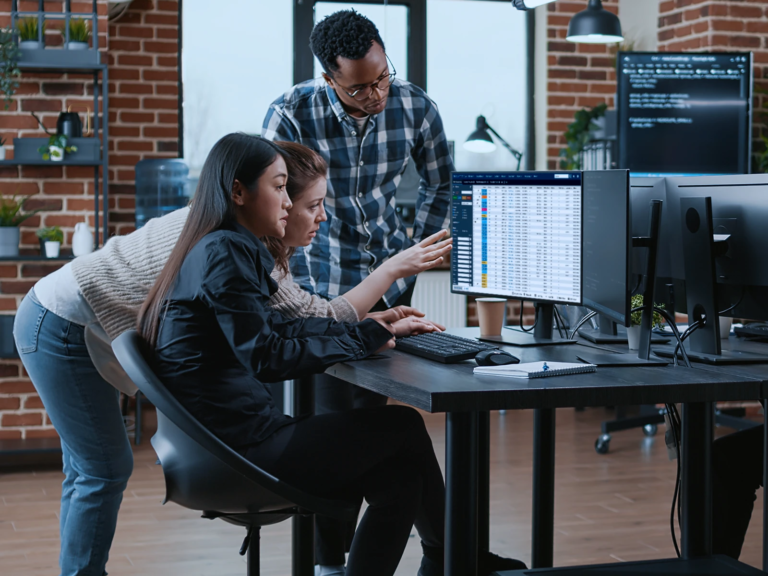 Image of Freight brokers in an office, looking at a computer